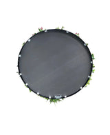 Een Kunsthaag op Zwart Frame Ø100 cm, met kleine groene plantjes en roze bloemen op een rond zwart dienblad, van bovenaf gezien tegen een witte achtergrond.