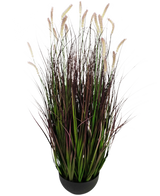 Artificial Grass Caterpillar Onion Grass Bonsai er en 100 cm, flammehæmmende kunstig plante med lange grønne og mørkelilla blade med bløde, cremefarvede faner, afbildet mod en almindelig hvid baggrund.